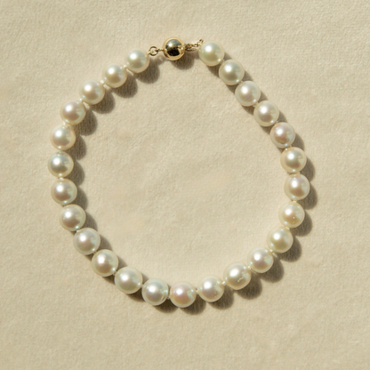 Pearl bracelet on a beige background