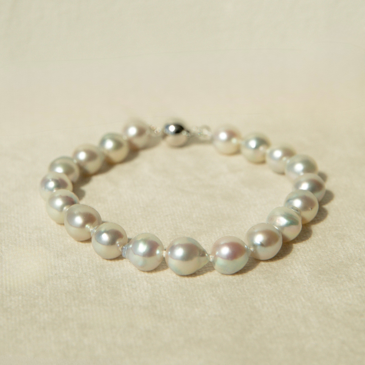 Pearl bracelet on a beige background