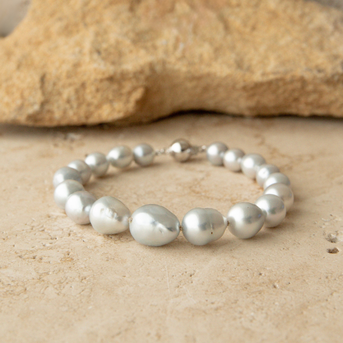 Baroque pearl strand bracelet on a textured stone surface