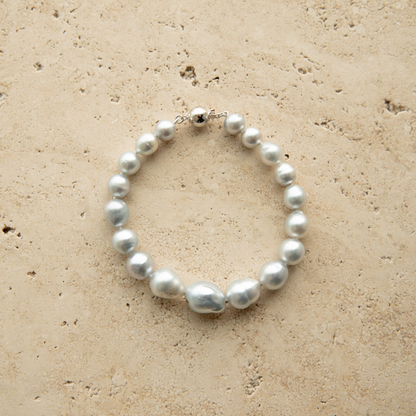 Baroque pearl strand bracelet on a textured stone surface
