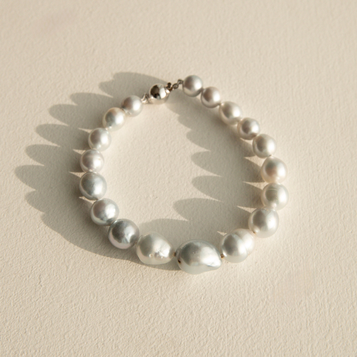 Baroque pearl strand bracelet on a textured stone surface