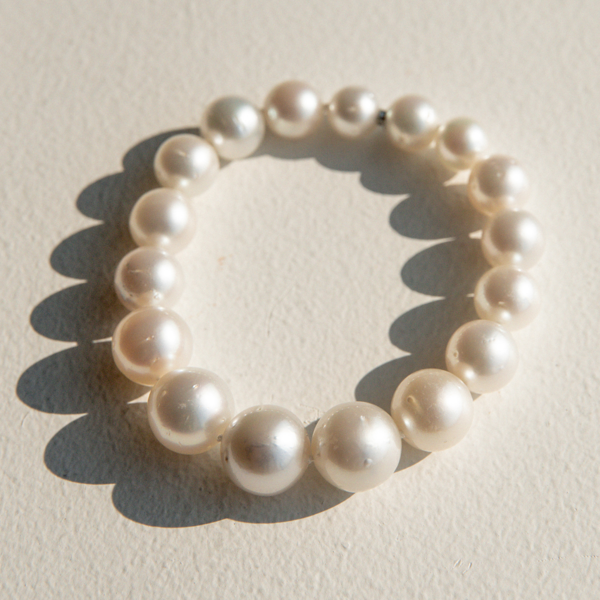 Pearl  strand bracelet on a light beige background