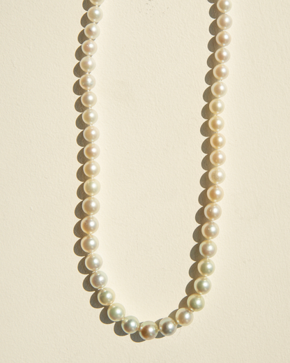 Pearl necklace on a beige background