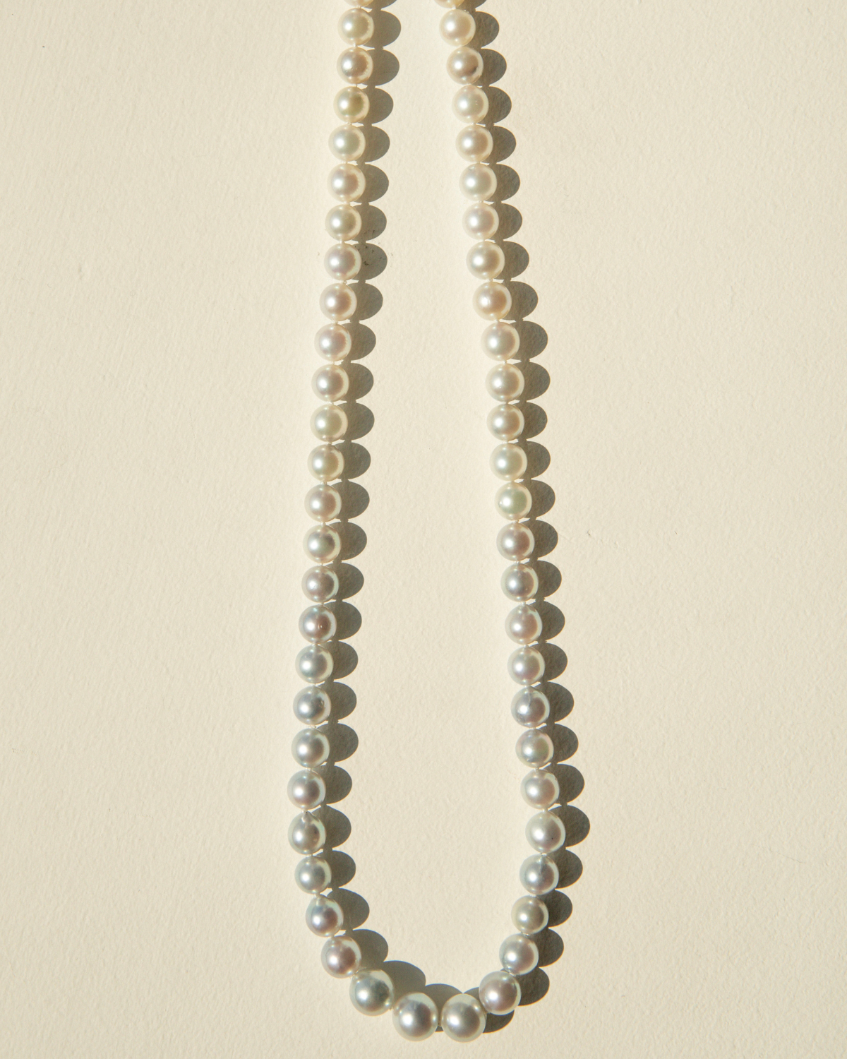 Pearl necklace on a beige background