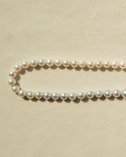 Pearl necklace on a beige background