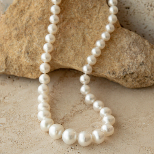 Pearlstrand necklace on a textured stone surface