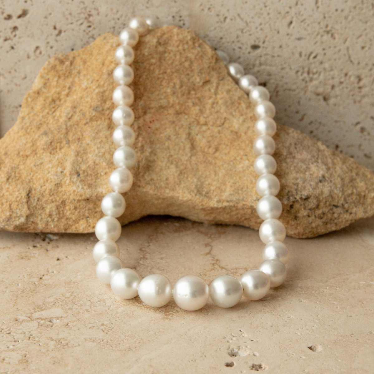 Australian pearl strand necklace on a stone surface