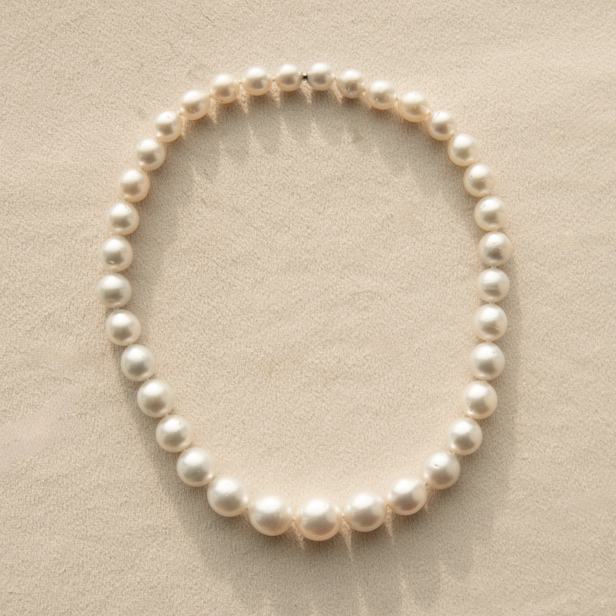 Australian pearl necklace on a beige surface
