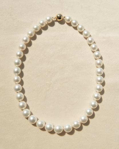 Pearl necklace on a beige background