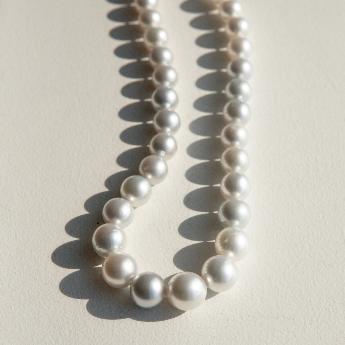Pearl strand necklace on a light background