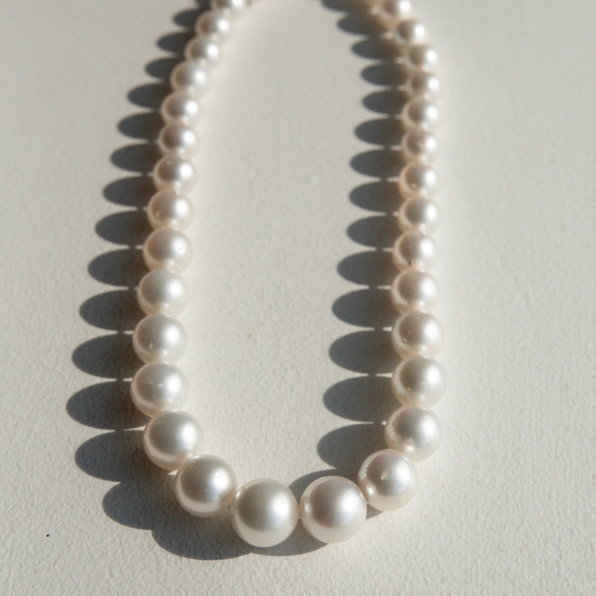 Pearl strand necklace on a light background