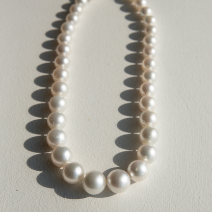 Pearl strand necklace on a light background