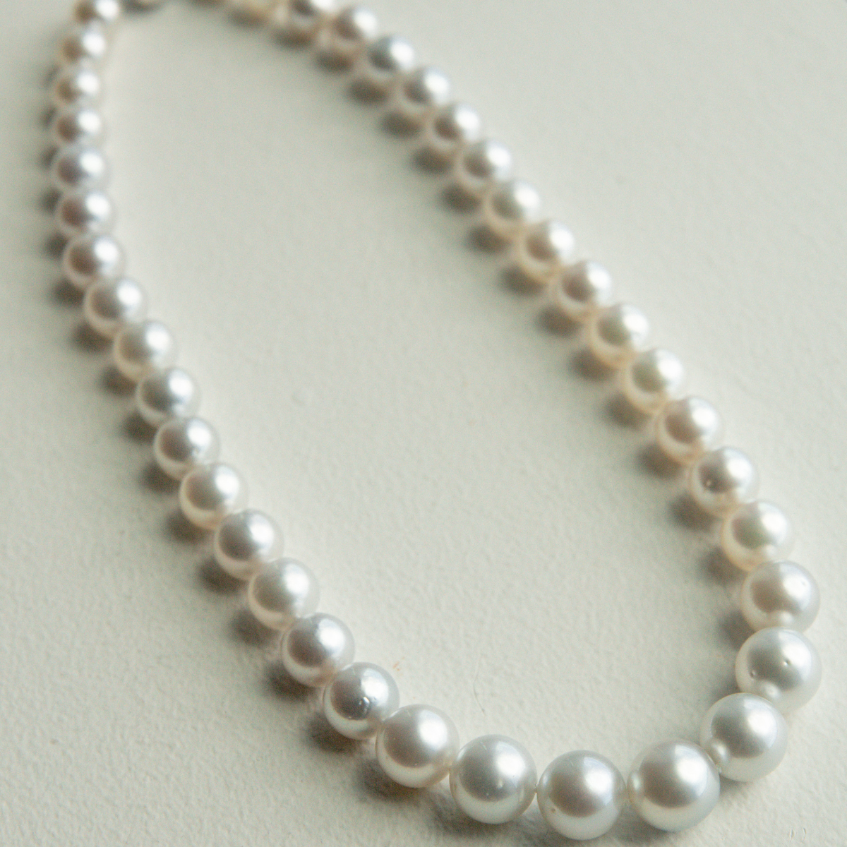 Pearl strand necklace on a light background