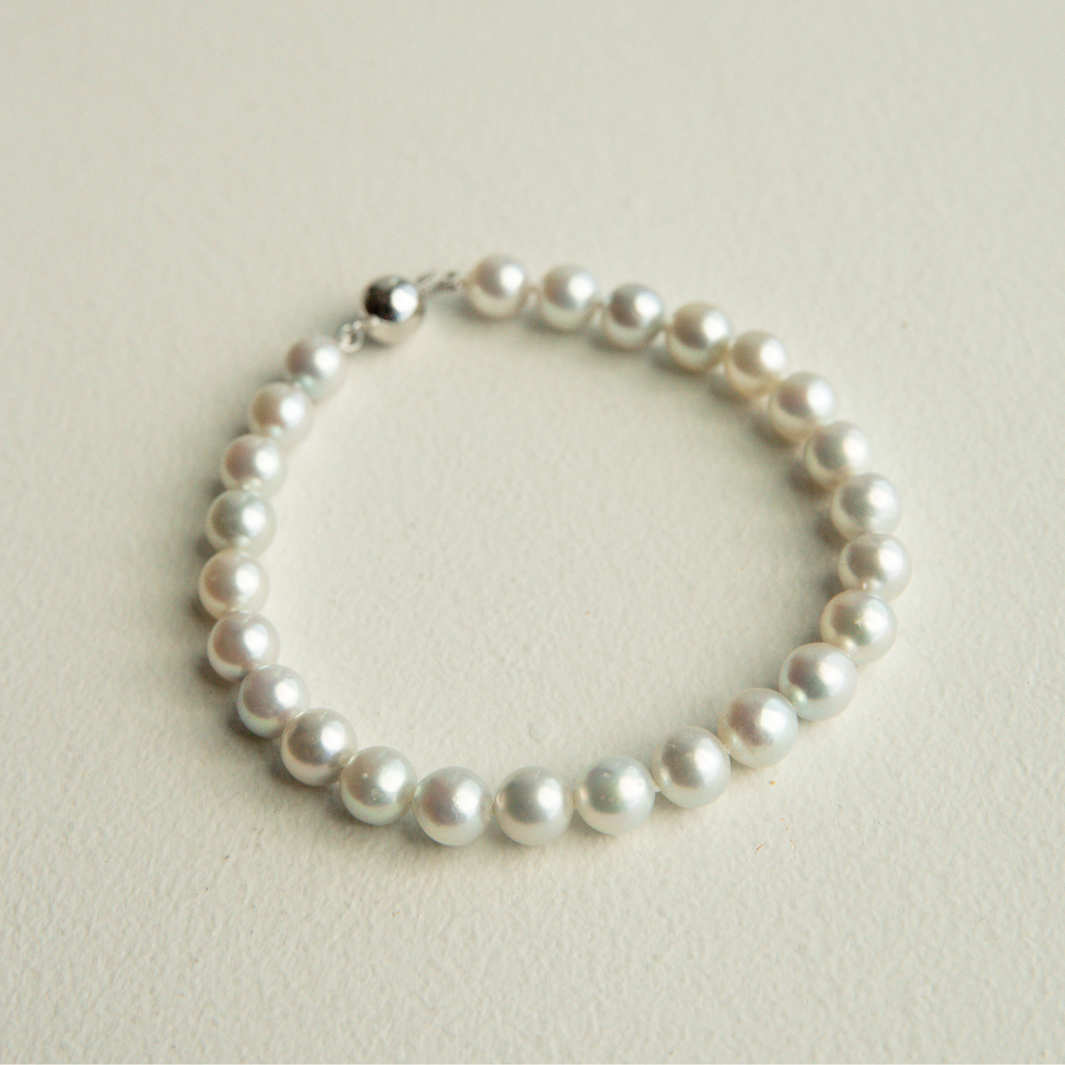 Pearl bracelet on a light beige background