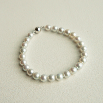 Pearl bracelet on a light beige background