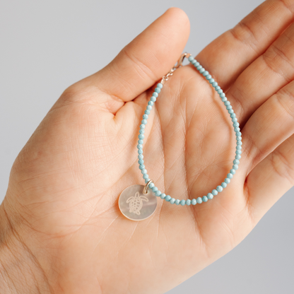 As part of our partnership with Take 3 for the Sea, we have crafted an Aquamarine charm bracelet featuring our beautiful Australian Mother of Pearl shell from our Cygnet Bay Pearl Farm. Available in two sizes, and set with an adjustable parrot clasp.
