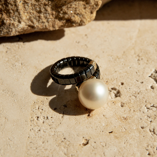 Black ceramic ring with stunning South Sea pearl, set on a stone.