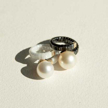Two ceramic rings, set with stunning Australian South Sea pearls, set alongside white sparking diamonds.