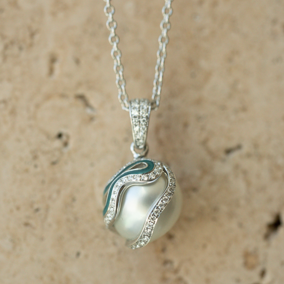 Pearl pendant necklace with a textured beige background