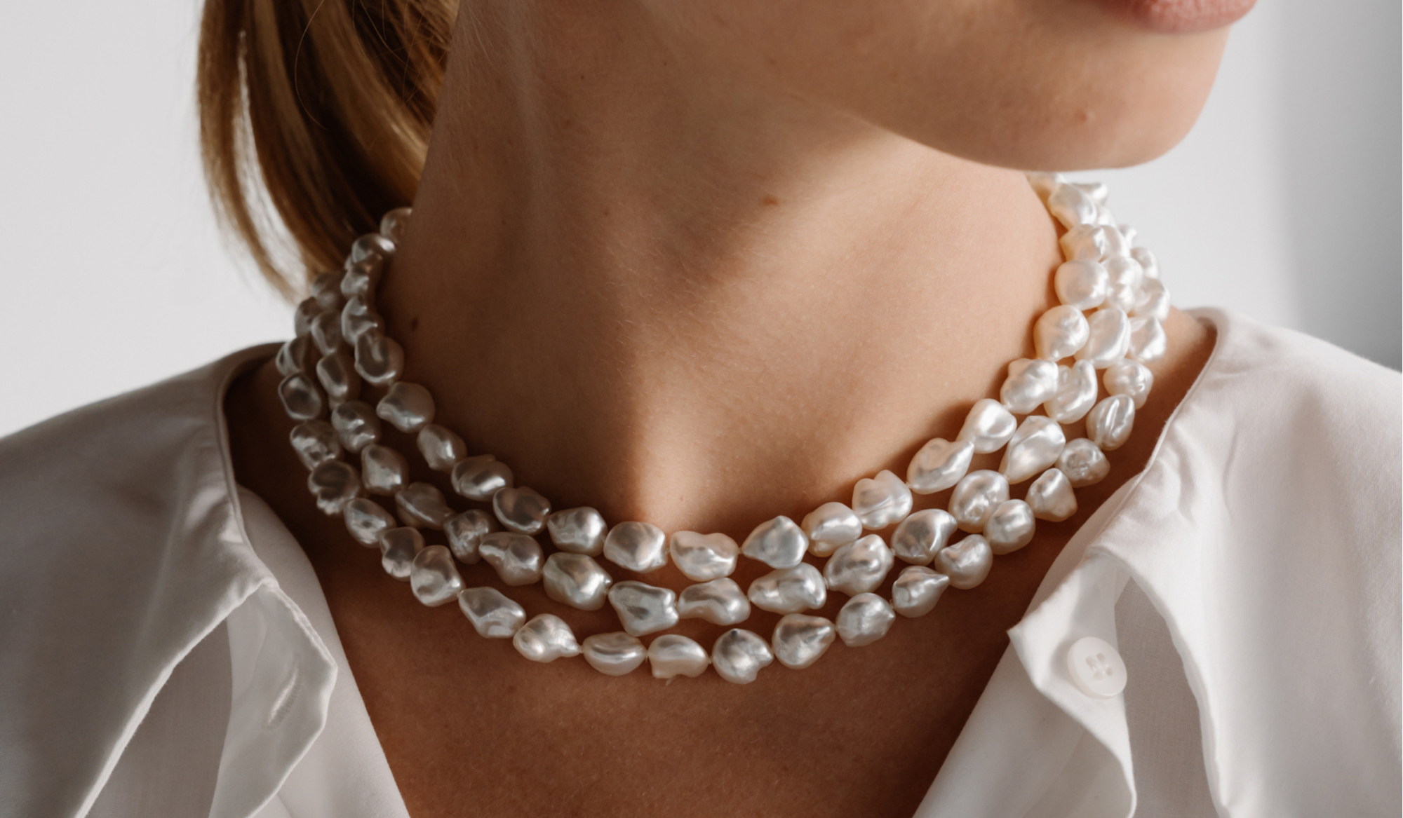 A triple keshi pearl strand necklace is worn by a person, shining with its innate colour and lustre and adored for its unique look and shape.