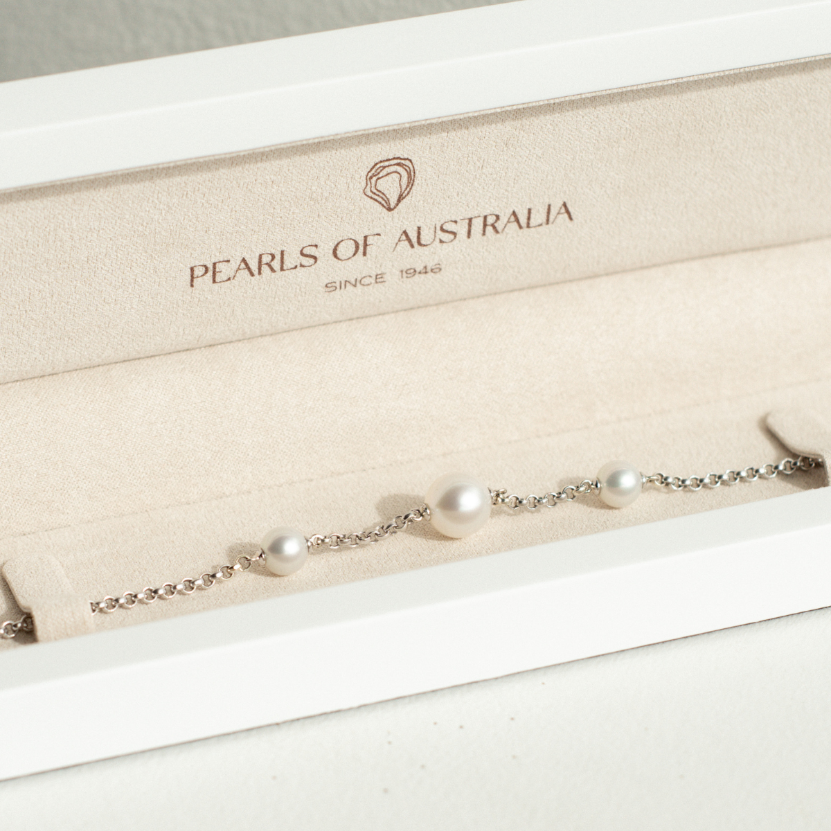 Pearl bracelet on display with 'Pearls of Australia' branding in the background