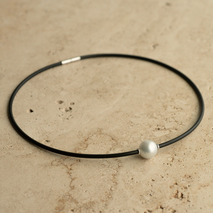 A gorgeous Australian South Sea pearl set alongside two white gold rondels on a neoprene necklace.