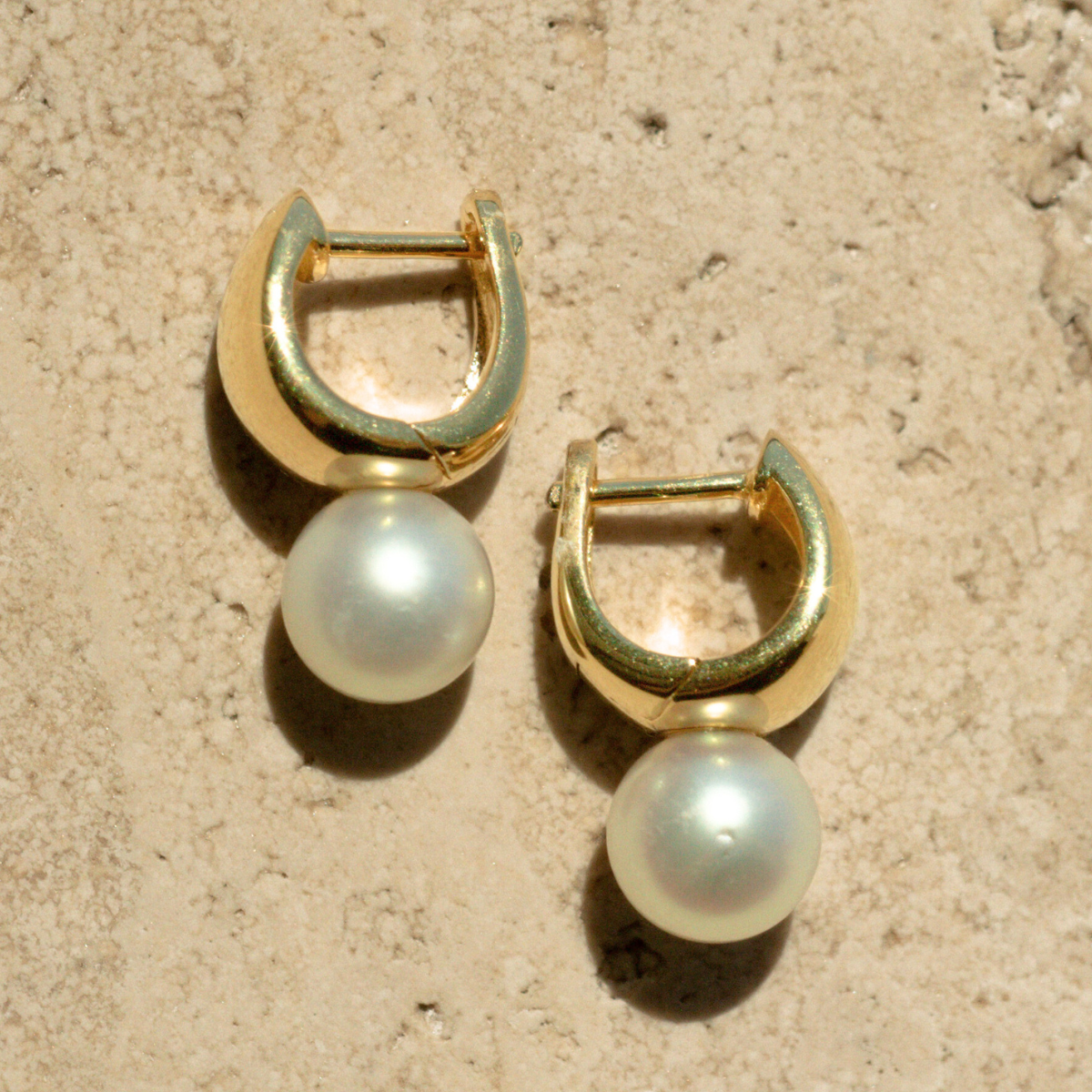 A pair of Rounded Wide Pearl Huggie Earrings featuring a pair of Broken Bay (NSW) grown 7.5mm AA grade (moderately blemished) Australian Akoya pearls grown at our very own Broken Bay Pearl Farm and set in gold plated sterling silver.