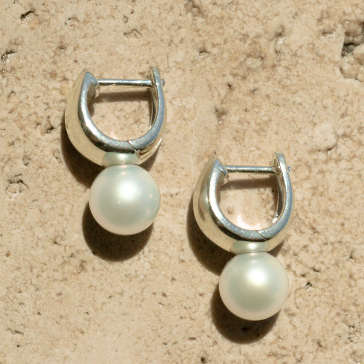 A pair of Rounded Wide Pearl Huggie Earrings featuring a pair of Broken Bay (NSW) grown 7.5mm AA grade (moderately blemished) Australian Akoya pearls grown at our very own Broken Bay Pearl Farm and set in sterling silver.