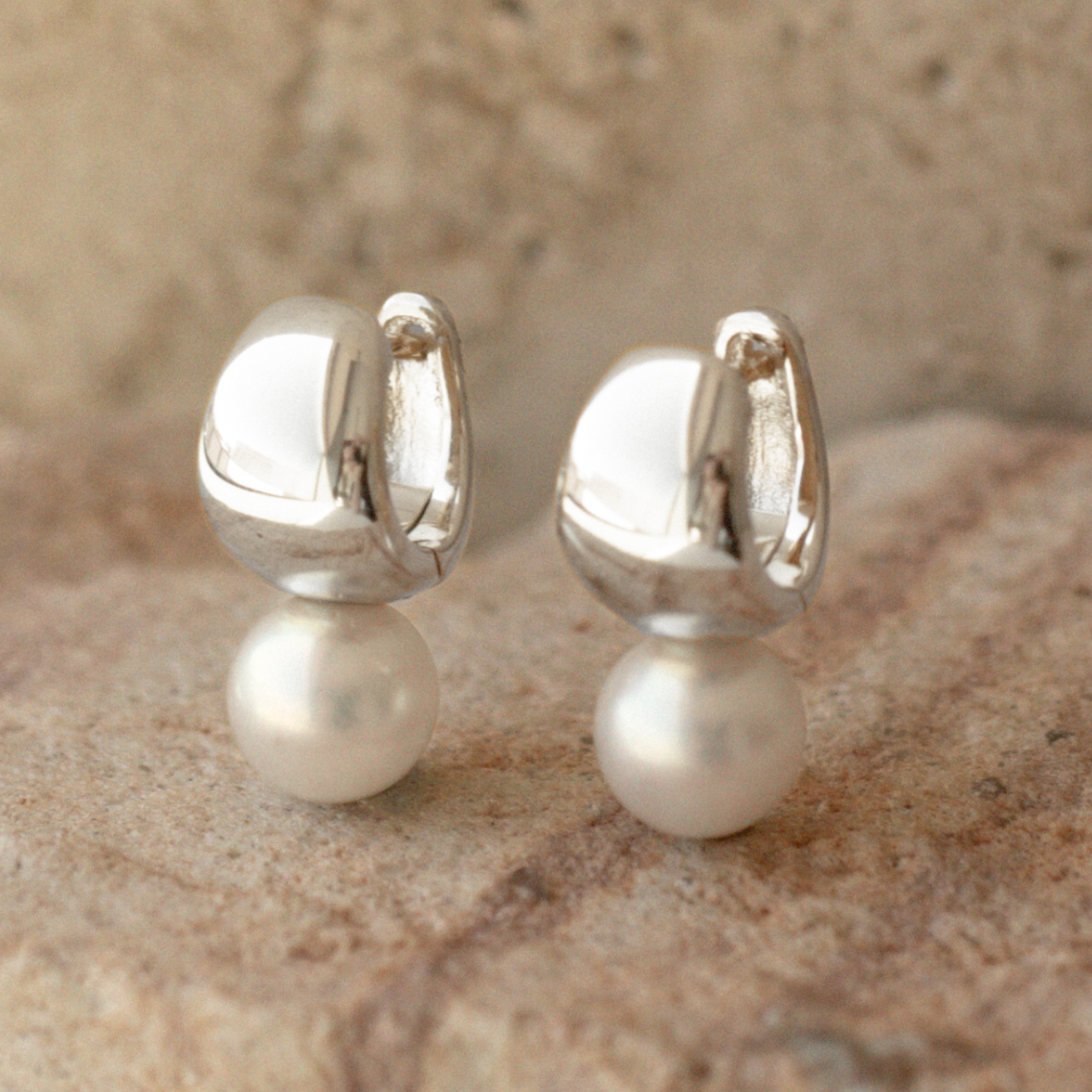 A pair of Rounded Wide Pearl Huggie Earrings featuring a pair of Broken Bay (NSW) grown 7.5mm AA grade (moderately blemished) Australian Akoya pearls grown at our very own Broken Bay Pearl Farm and set in sterling silver.