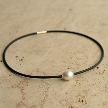 A gorgeous Australian South Sea pearl set alongside two yellow gold rondels on a neoprene necklace.