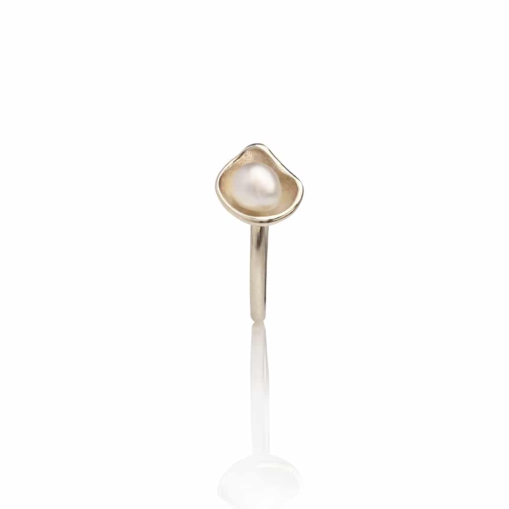 Gold ring with a pearl on a white background
