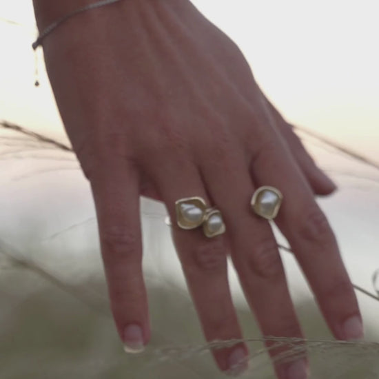 A woman wears her Kimberley Lily Float Ring that features Cygnet Bay grown Keshi pearls set in solid gold organic shape designs. 