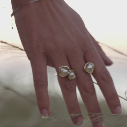 A woman wears her Kimberley Lily Float Ring that features Cygnet Bay grown Keshi pearls set in solid gold organic shape designs. 