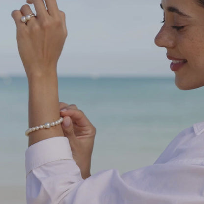 A woman wears a beautiful Eternal Diamond Pearl Strand Bracelet featuring our Australian grown South Sea and Akoya pearls set with two diamond rondels.