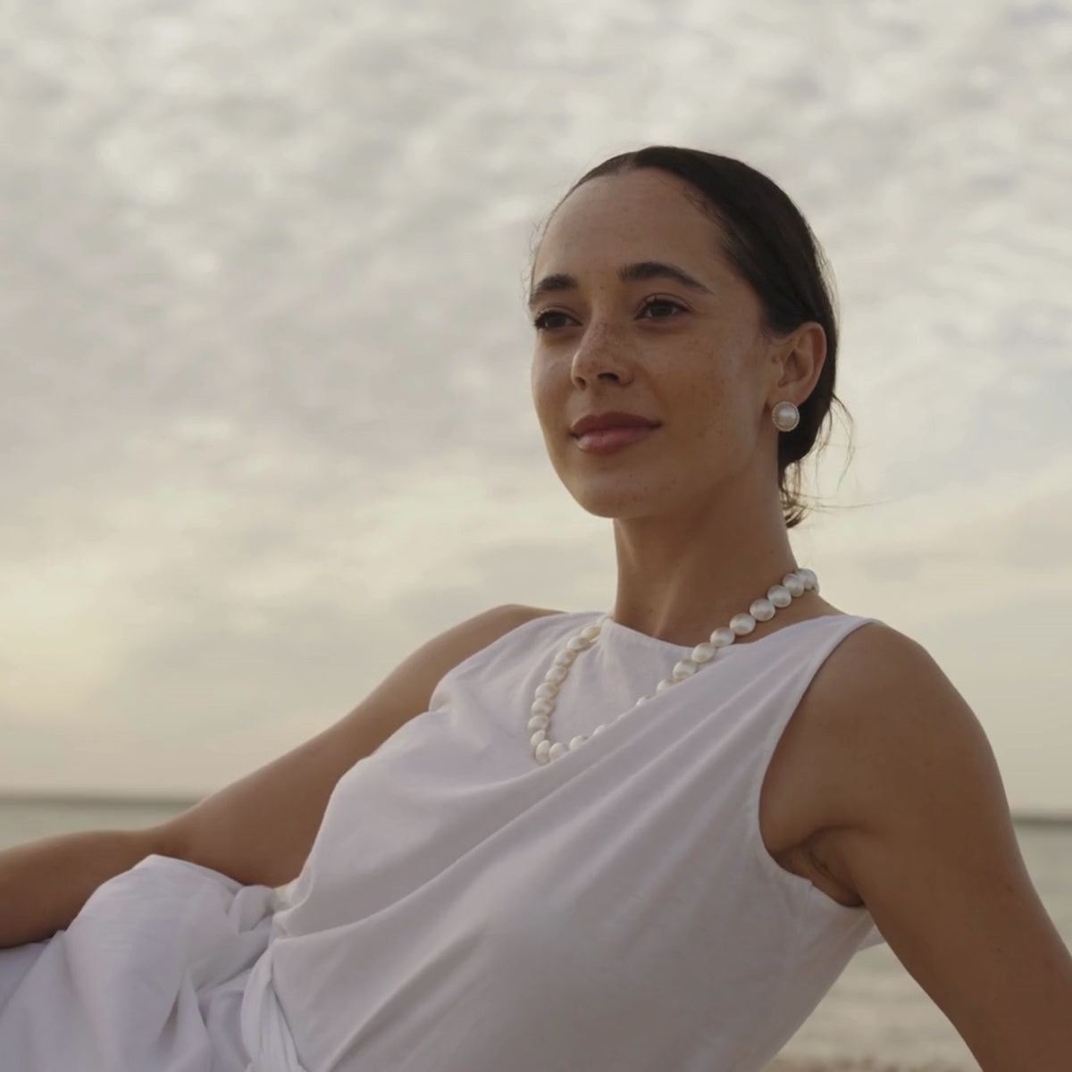 A woman wears her stunning Mabe Pearl Strand Necklace featuring our Cygnet Bay grown Mabe or blister pearls.